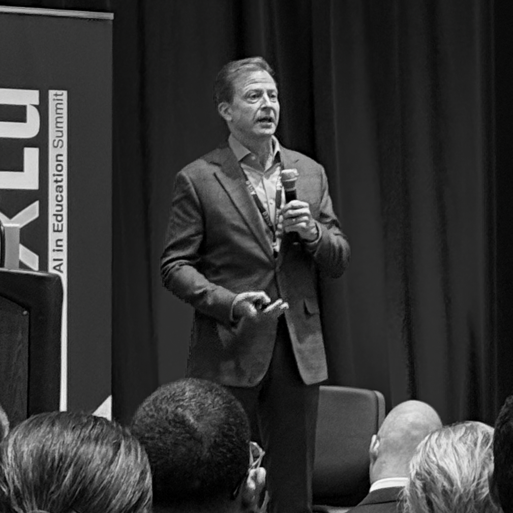 a man standing in front of a crowd holding a microphone